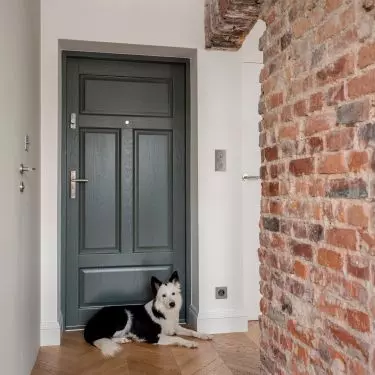 Brick wall divides space into living and bedroom areas