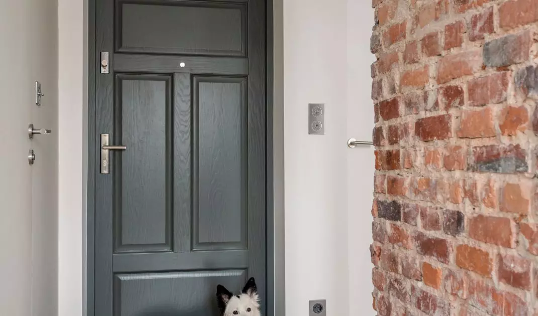 Brick wall divides space into living and bedroom areas