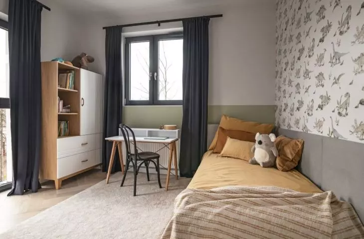 In the room of the second son there is dinosaur wallpaper