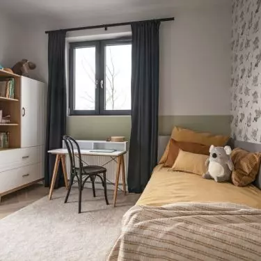 In the room of the second son there is dinosaur wallpaper