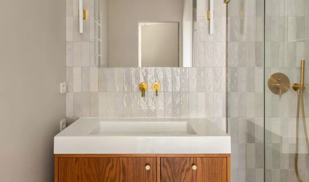 The bathroom is dominated by wood and gold