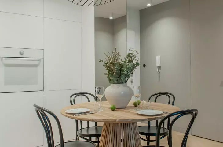 The table with chairs is the focal point of the apartment