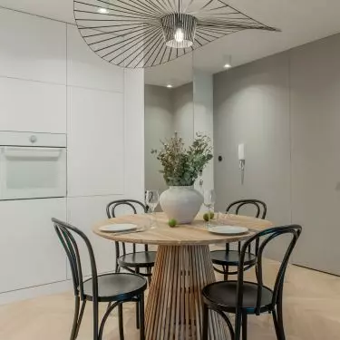 The table with chairs is the focal point of the apartment