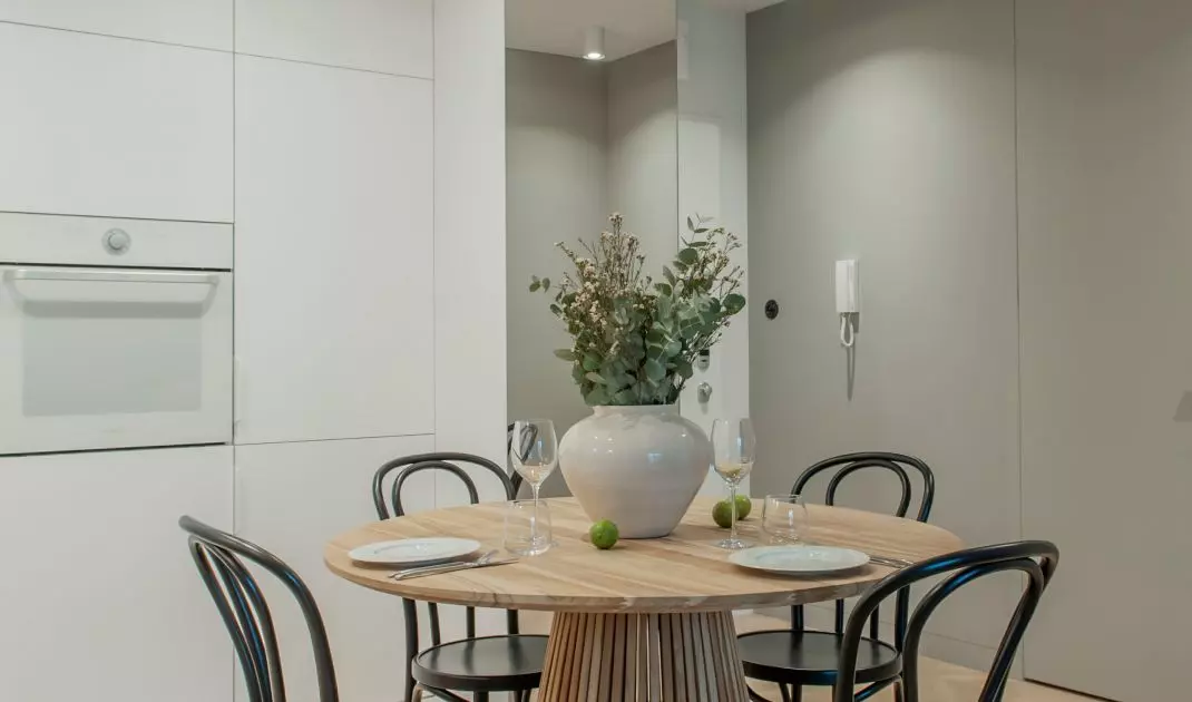 The table with chairs is the focal point of the apartment