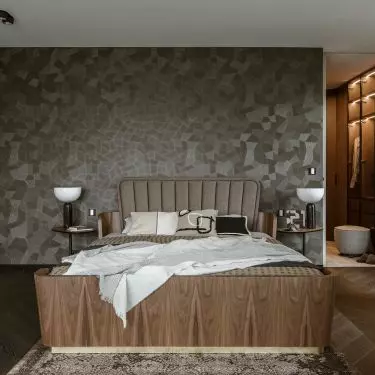 Behind the bed is a mosaic wallpaper