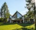 The house in Lekarty, in spring, view from the side of the lake