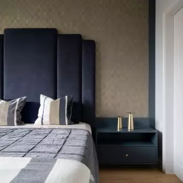 Bed with upholstered headrest