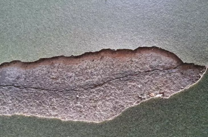 Cracked floor under a layer of resin
