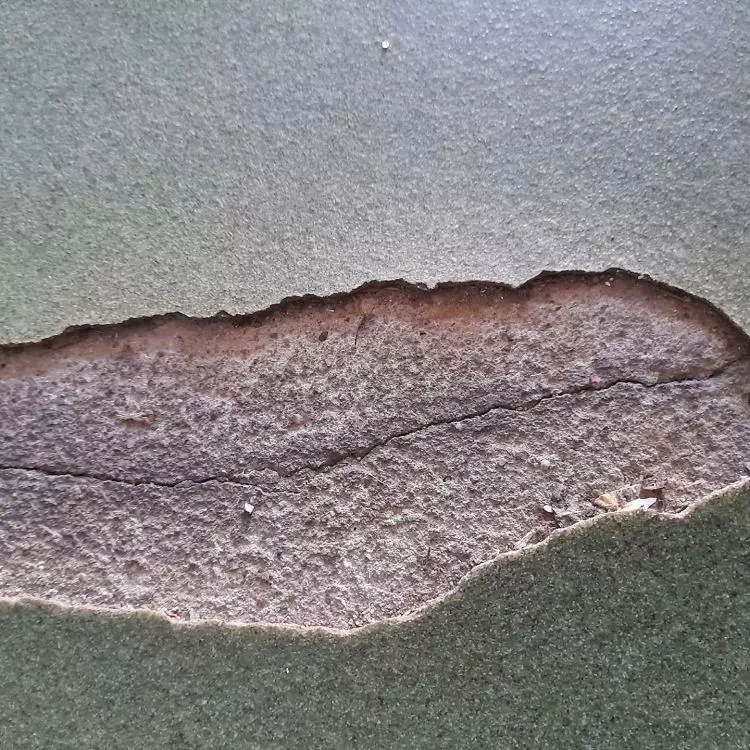 Cracked floor under a layer of resin