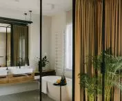 The glass door between the bedroom and bathroom can be covered with a heavy curtain