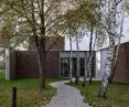 Greenery highlights the entrance to the building