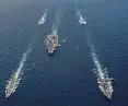 A strike aircraft carrier never sails alone; with cover and support ships, the team's population often exceeds 10,000 residents 