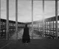 Tall and narrow windows correspond with the openwork walls of the corridors that run around the sheet of water