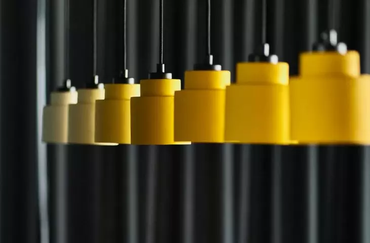 Yellow lamps contrast with the dark background