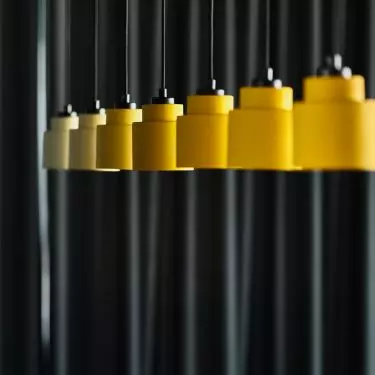 Yellow lamps contrast with the dark background