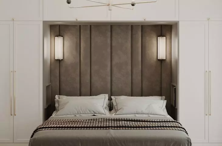 In the center of the bedroom is an upholstered bed 