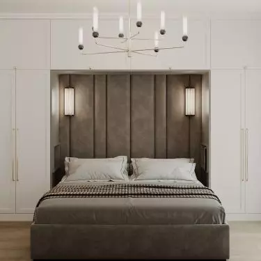 In the center of the bedroom is an upholstered bed 