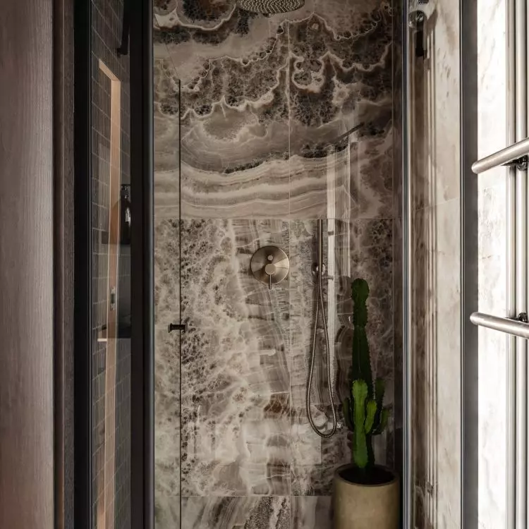 The bathroom uses richly textured tiles