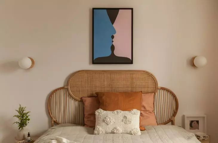 The bedroom wall is decorated with a poster