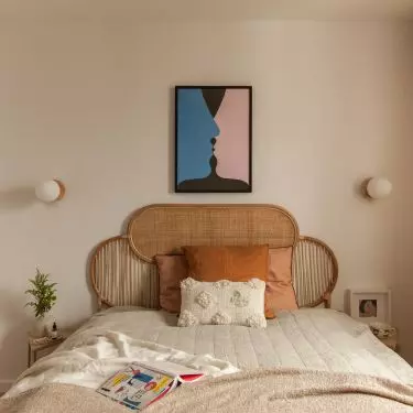 The bedroom wall is decorated with a poster