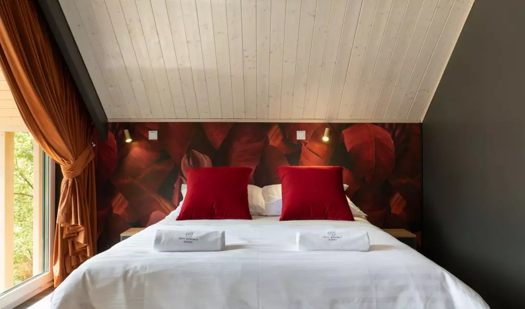 Bedroom with wallpaper with banana leaf motif