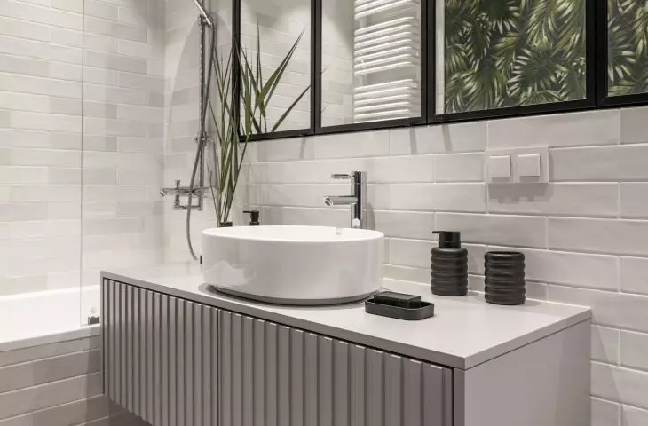 The dominant color in the bathroom is gray