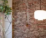 The architect decided to leave the brick wall in place