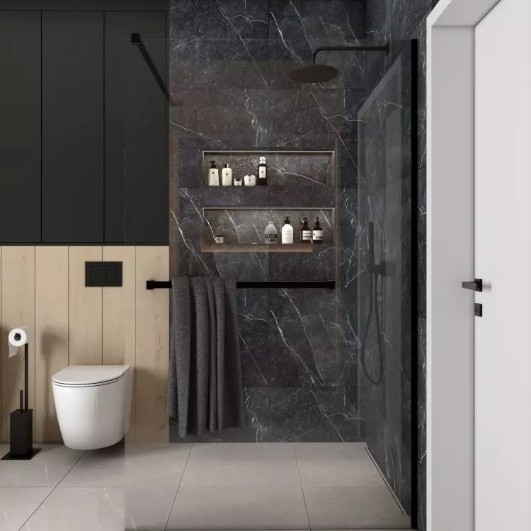 The shower area is lined with black tiles