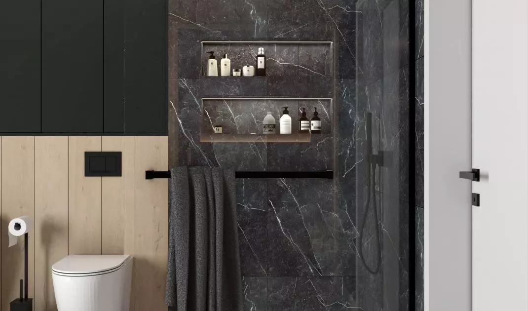 The shower area is lined with black tiles