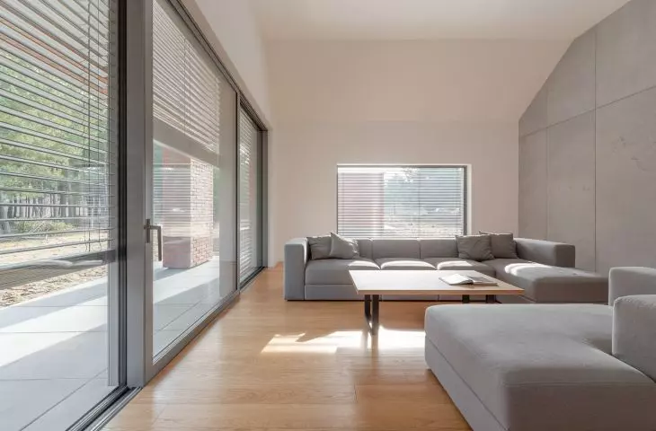 The living room has large glass windows