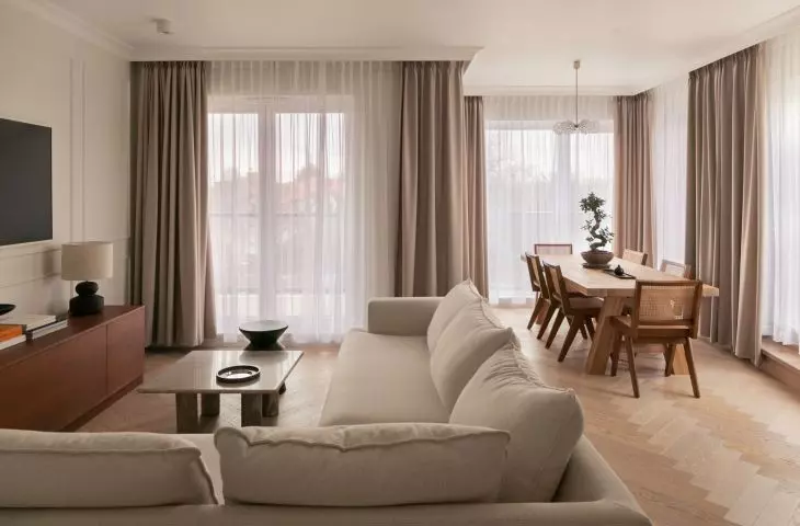 The center of the apartment is a living room with a dining room