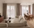 The center of the apartment is a living room with a dining room
