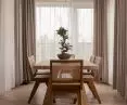 The dining space features a large wooden table and a crystal chandelier