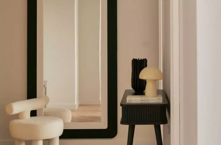 In the lobby there is a large mirror in a black frame