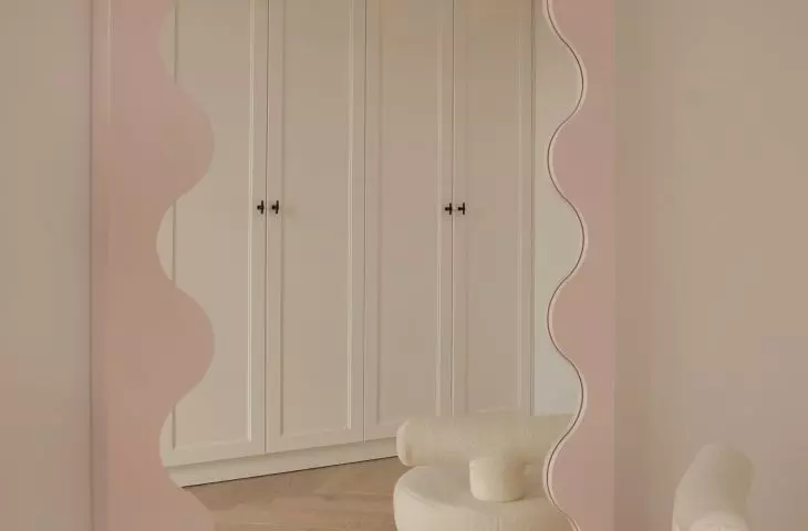 Attention is drawn to the unusual frame of the mirror