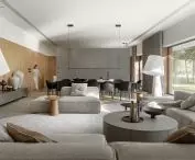 The gray-wood color scheme carries over from the facade to the interior of the living area; window lintels line the exterior and interior where the wood paneling reaches