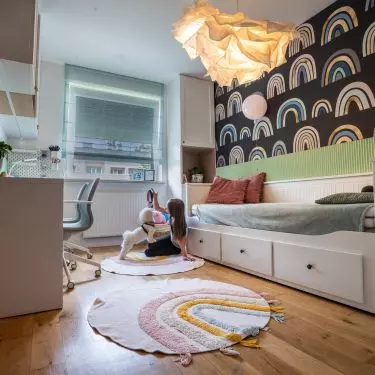A rainbow motif appears in the girls' room