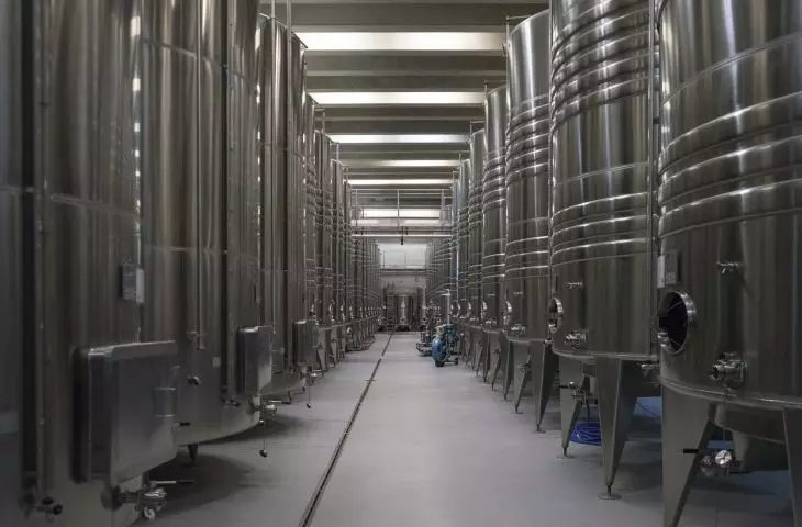two production halls (2008) designed by Jean Nouvel took the forms of half-cylinders covered with corrugated aluminum sheeting; fermentation tanks are located in the underground part of one of them 