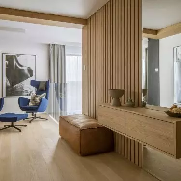 A wooden carpet staircase leads upstairs