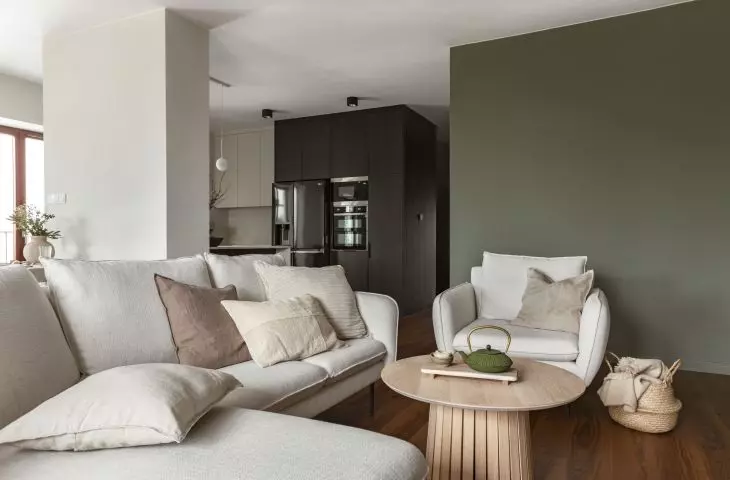 Lounge area with a bright sofa and armchairs
