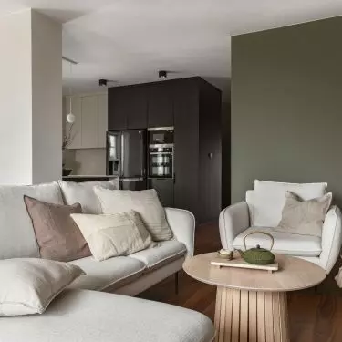 Lounge area with a bright sofa and armchairs