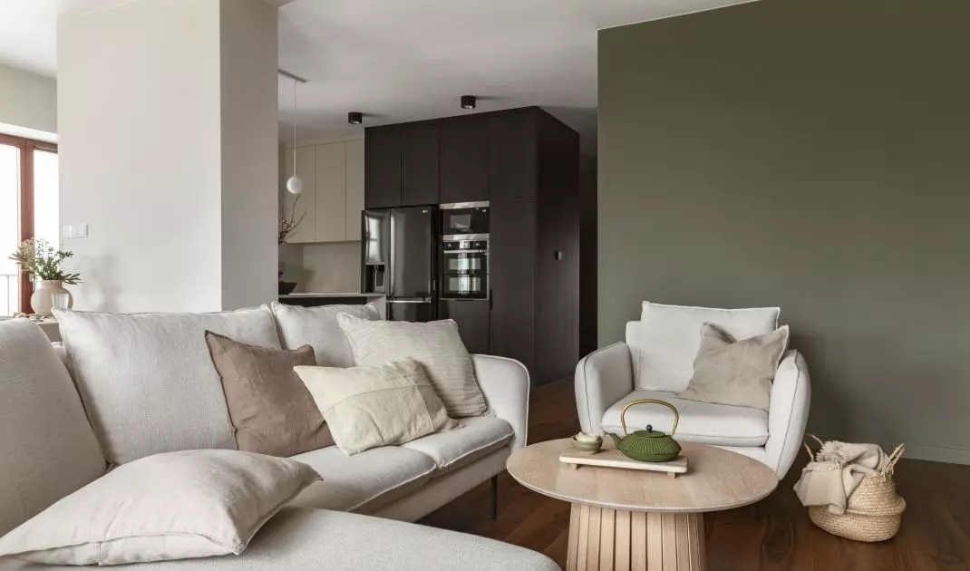 Lounge area with a bright sofa and armchairs
