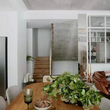 Interior combines raw finishes with warm woods