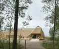 The tradition of using reeds as a building material inspired architect Gert Wingårdh to use reed thatch on the exterior of the building; the steep pitch of the roofs gives the thatch an estimated lifespan of more than fifty years