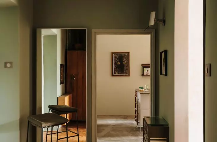 The floors of the entire apartment are decorated with herringbone parquet flooring