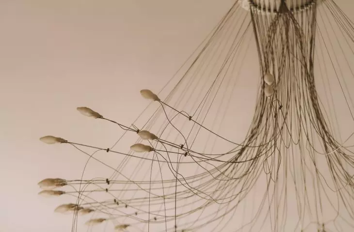 The hanging lamp in the living room has 36 bulbs and is a sculpture in itself