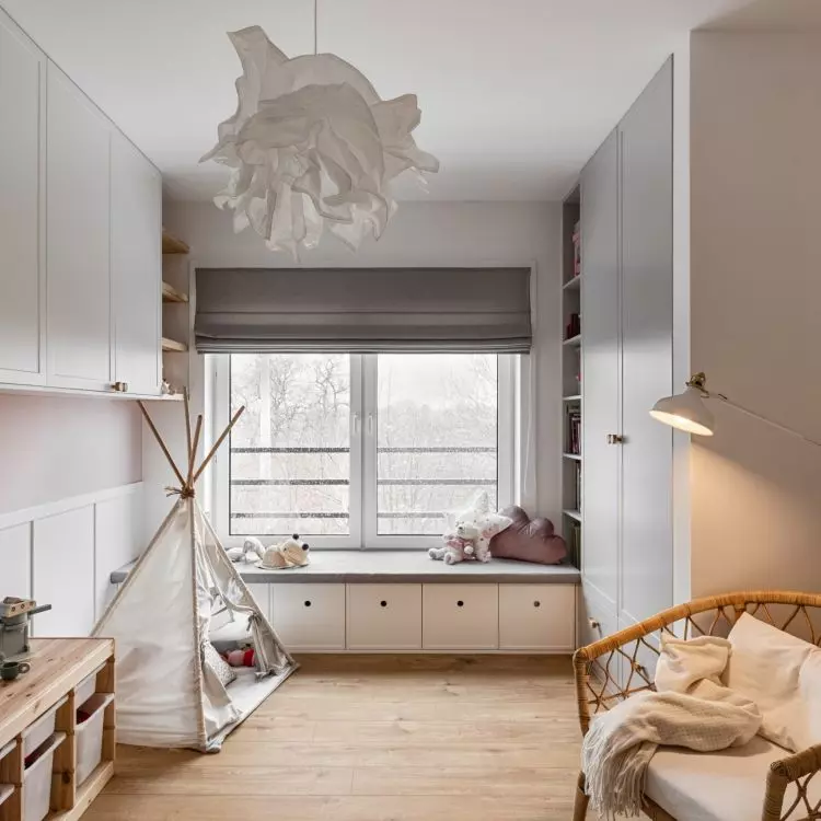 The girl's room is kept in white gray and pink