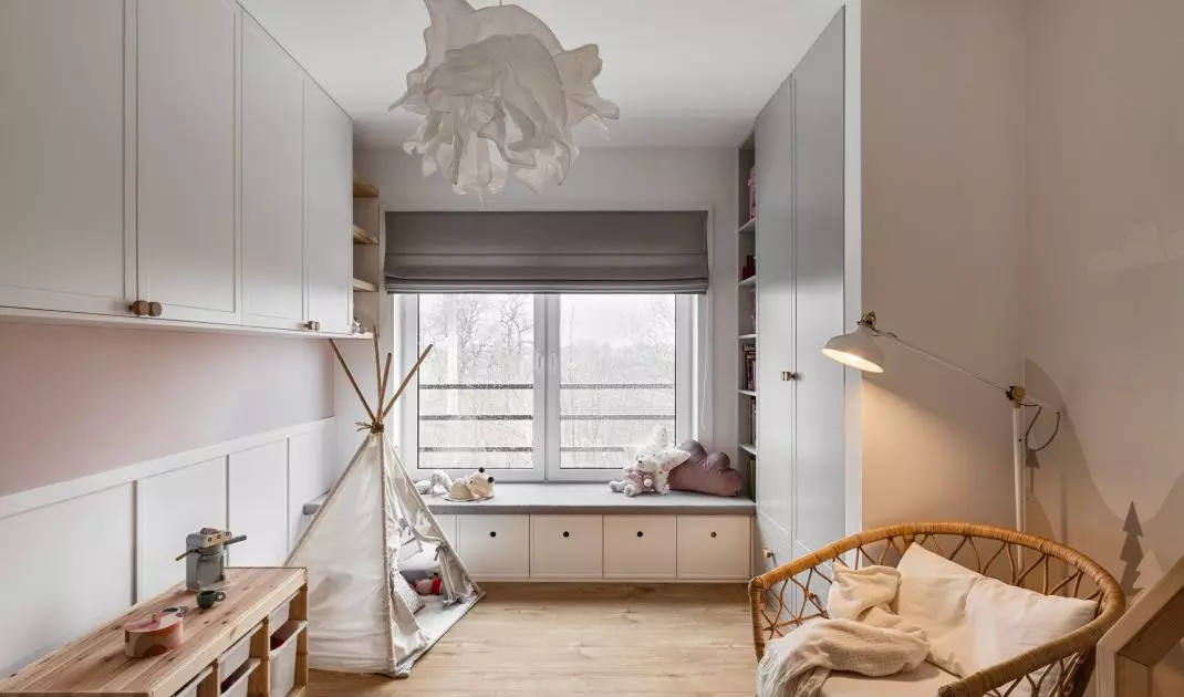 The girl's room is kept in white gray and pink