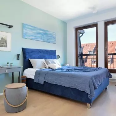 Bedroom with a painting by Magdalena Ignaczak
