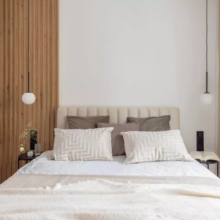 The focal point of the arrangement is the upholstered bed